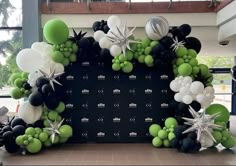 an arch made out of balloons and starbursts is displayed in the lobby