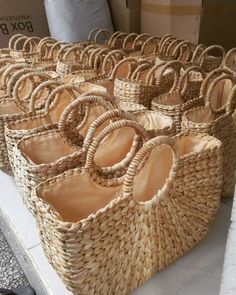 many woven baskets are lined up on the floor