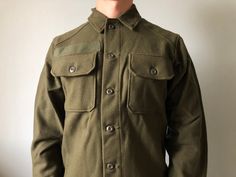 Deadstock US Army / Wool Shirt / 1970's / Size S / Military Shirt This vintage military shirt is in wonderful new condition (deadstock) - made in USA - ERA 1970's - color - green - 2 outside pockets - 6 buttons at front - 2 button on the cuffs - material - wool 80% , nylon 20% - label size - S (watch measurements) FLAT Measurements: Shoulders : 18 inches (46cm) Chest (underarm to underarm) : 22 inches (56cm) Sleeve : 24 inches (61cm) Length(back) : 29 1/2 inches (75cm) Pay your attention to that Green Buttoned Tops For Outdoor, Green Military Style Work Tops, Green Military Style Workwear Top, Green Military Style Tops For Work, Fitted Military Tops With Pockets, Workwear Overalls, Swedish Army, Military Surplus, Wool Shirt