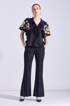 Black ruffled top with floral embroidered peplum sleeves. Paired with a bootcut pant. - Aza Fashions Black Ruffled Pants For Fall, Chic Black Spring Sets, Chic Black Sets For Spring, Black Ruffled Pants For Spring, Fall Workwear Pants With Ruffles, Spring Fitted Pants With Flared Cuffs, Spring Workwear Sets With Ruffles, Fitted Pants With Flared Cuffs For Spring, Chic Spring Bottoms With Flared Cuffs