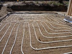 an image of a house under construction with pipes going through the floor and in the ground