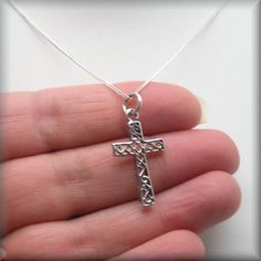 "A lovely sterling silver cross has the added interest of a scrollwork pattern added to the center sections. Wonderful for everyday wear for someone who wants a necklace of faith. The pendant is 1\" long (2.54 cm). The bail adds about 1/4\" more in length. Both pendant and curb chain are sterling silver. Items are shown larger in pictures to show detail - please note the dimensions. Jewelry is packaged in a cotton lined box for gift-giving. See more Bonny Jewelry at http://bonnyjewelry.etsy.com Silver Cross Pendant Jewelry For Baptism, Filigree Crucifix Necklace For Gift, Silver Crucifix Necklace For Baptism, Crucifix Filigree Necklace For Gift, Engraved Sterling Silver Cross Necklace Gift, Silver Cross Pendant Jewelry For First Communion, Sterling Silver Cross Pendant Necklace For First Communion, Sterling Silver Cross Necklace For First Communion, Silver Cross Necklace For Baptism