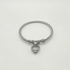 Stainless steel bracelet with heart charm Minimalist Heart-shaped Metal Bracelets, Minimalist Metal Bracelet With Heart Charm, Minimalist Stainless Steel Bracelets With Heart Charm, Everyday Stainless Steel Bracelet With Heart Charm, Everyday Stainless Steel Heart Bracelet With Charm, Everyday Stainless Steel Heart Bracelet, Trendy Metal Heart Charm Bracelet, Everyday Silver Metal Heart Bracelet, Trendy Metal Charm Bracelet With Heart Charm