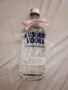 a bottle of absolut vodka with a pink bow on the top and bottom