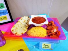 there are many different foods on the trays at this party, including tortillas and chips