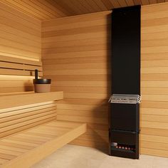 an empty sauna with wooden walls and benches in the corner, along with a potted plant