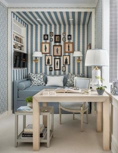 a living room filled with furniture and pictures on the wall next to a table in front of a couch