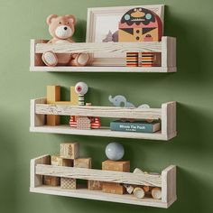 two wooden shelves with teddy bears and toys on them against a green wall in a child's room