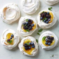 small desserts with fruit on them are arranged in the shape of flowers and leaves