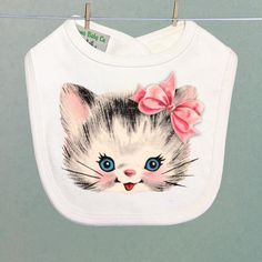 Adorable retro kitten with bow, available in pink or blue, on our high-quality organic infant or toddler bib. Gift wrap available for only $4 here: https://www.etsy.com/listing/568458201/gift-wrap-organza-ribbon-and-tissue-with?ref=shop_home_feat_3"Natural" off-white, 100% organic cotton. "Hook-and-loop" closure. Made in the U.S. Machine wash and dry, with NO bleach.Please choose sizing carefully, and if you need any help just contact us and ask. We personally make each of your items to your spe Kitten With Bow, Cat With Bow, Retro Baby Showers, Rodeo Gifts, Retro Trailer, Toddler Bib, Cadeau Baby Shower, Toddler Bibs, Retro Baby