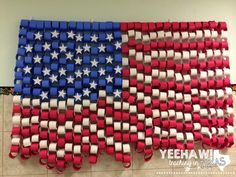 an american flag made out of legos on the floor in front of a wall