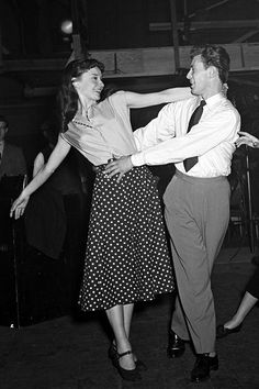 a man and woman are dancing on the dancefloss in an old - fashioned black and white photo