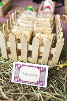 there are many pieces of food in the basket on the hay with a name tag next to it