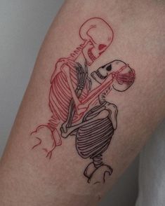 a person with a skeleton tattoo on their arm