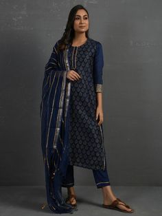 A gold hand block printed chanderi kurta in indigo with gota details in placket and cuff. The piece comes with a matching slip in mul and pants with elasticated - draw string adjustable waist band Kurta measurements (in Inches): Size S: Bust - 39", Waist - 38" Size M: Bust - 42", Waist - 41" Size L: Bust - 45", Waist - 44" Length: 47", Sleeve length: 17" Pant Measurements (in Inches): Size S: Waist - 30-32" Size M: Waist - 33-35" Size L: Waist - 36-38" Length: 35" Fabric: Chanderi (Cotton silk) Indigo Printed Straight Kurta Set, Chanderi Block Print Churidar With Long Sleeves, Bandhani Print Chanderi Palazzo Set With Straight Kurta, Chanderi Bandhani Print Palazzo Set With Straight Kurta, Long Sleeve Chanderi Churidar With Block Print, Indigo Straight Kurta Set For Eid, Indigo Block Print Sets For Diwali, Indigo Navratri Set With Dupatta, Festive Block Print Straight Kurta Salwar Kameez