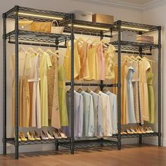 an open closet with clothes and shoes hanging on the racks, in front of a hardwood floor