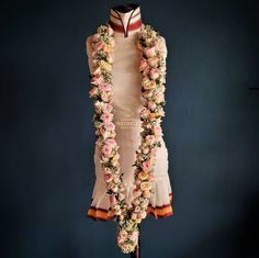 a mannequin is adorned with flowers and garlands for the bride's wedding