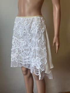 Easy breeze wrap dressy skirt. Hand Made Lace Embellished With Ribbons and 100% Silk Chiffon. Lace is 100%pure cotton.   The skirt is uneven , but we can still  call it short skirt.  Because it's a wrap skirt , can fit many sizes, you can wear it at waist or below waist, over  three inches for overlap. The whole skirt is lined with Off White Silk Chiffon. Opened on the sides but the open is  well covered by the chiffon ruffles. Measurements- Waist----------  overlap for 28,32, and 33in Length---------- Left side 23in                            Right  side 21in Back-   24in Fitted Bohemian Wrap Skirt For Summer, Summer Festival Lace Skirt, Fitted Cotton Wrap Skirt For Festivals, Bohemian Fitted Dress With Asymmetrical Skirt, Fitted Bohemian Dress With Asymmetrical Skirt, Elegant Relaxed Fit Cotton Wrap Skirt, Knee-length Fitted Wrap Skirt For Summer, Summer Wedding Dress With Asymmetrical Skirt, Fitted Cotton Wrap Skirt For The Beach