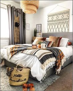 a bedroom with a bed, rugs and baskets on the floor in front of it