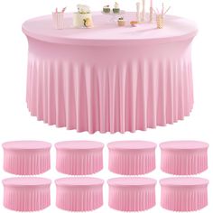 a round table with pink pleated cloths and place settings