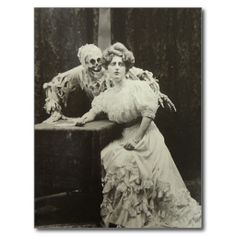 an old black and white photo of two women dressed as zombies sitting next to each other