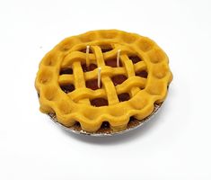 a close up of a pie on a white surface