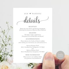 a person holding up a card with the words, our wedding details