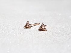 Intricately hand-sculpted triangular pyramid stud earrings in 14k rose gold, encrusted with brilliant, full-cut white diamonds in micropavé setting. Striking yet understated you'll want to wear them forever. Available as a single or as a pair. DETAILS 5mm x 5mm * Full-cut diamond: VS grade, G color * 14k rose gold setting, post and backing * Ethically sourced and handcrafted with love & care * Complimentary gift wrapping (See FAQ for details) OUR COMMITMENT - We design and handcraft our jewelry Shiney Things, 3d Triangle, Triangle Stud Earrings, Pyramid Shape, Pave Diamond Earrings, Triangle Earrings Stud, Triangle Studs, Earrings Diamond, Tiny Earrings