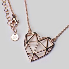 Geo-Heart is strong, she's complicated, she knows what she wants. The first necklace from our collection designed in-house, Geo-Heart follows the latest trend in geometric jewellery. Make a statement and wear her casually over a plain t-shirt or dressed up with a blouse. Either way, she rocks! Sterling silver with 18ct rose gold plating to 1.5 microns thickness. Jump rings allow the chain to be worn any length from 16 to 18 inches. Pendant measures 20 mm wide x 20 mm high. Modern Open Heart Jewelry For Gifts, Modern Open Heart Jewelry For Gift, Modern Jewelry With Heart Charm As Gift, Modern Jewelry With Heart Charm For Gift, Rose Gold Delicate Chain Necklace For Mom, Rose Gold Necklace With Delicate Chain For Mom, Rose Gold Heart Pendant Necklace For Her, Modern Jewelry With Heart Charm For Valentine's Day, Rose Gold Heart Pendant Necklace Gift For Her