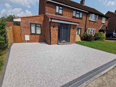 a house with a large driveway in front of it