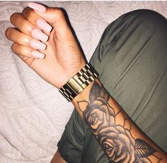 a man with a rose tattoo on his arm