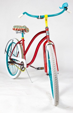 a red and blue bicycle is shown against a white background with the handlebars extended