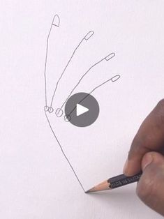 someone is drawing something on paper with a pencil