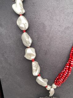 AD Blue Stone Black Stone Detachable Pendent Red Beads Mother Of Pearls MalaColor : SilverSize : Necklace Length : 24 InchesStones : Red Beads CZ Pearls Blue Stone Black Stone Elegant Red Beaded Pearl Necklace, Red Pearl Necklace For Party, Red Gemstone Beads Necklace For Party, Red Coral Necklaces For Party, Red Pearl Necklaces For Party, Red Beaded Pearl Necklace For Party, Red Coral Necklace For Party, Elegant Red Beaded Necklace With Colorful Beads, Party Red Pearl Necklaces