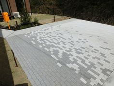 a skateboarder is doing a trick on the edge of a bricked area