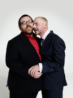 two men are hugging each other and smiling