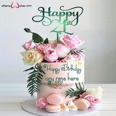 a birthday cake with pink flowers and greenery on the top that says happy birthday