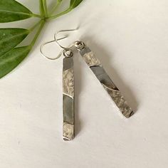 These dangly rectangular silver earrings are constructed from reticulated and smooth sterling. The light reflective ✨, textured surface of the reticulated silver combined with smooth brushed sterling sheet provides a striking contrast that makes these handmade earrings unique. A light patina has been applied to provide further contrast. The silver in these earrings is ♻️ recycled 925 sterling. The back of the earrings has a coarsely brushed finish. The ear wire is 20 gauge round sterling. ✅ To e Modern Silver Earrings With Rectangular Pendant, Modern Silver Rectangular Pendant Earrings, Hammered Silver Rectangular Jewelry, Rectangular Hammered Silver Jewelry, Rectangular Silver Hammered Jewelry, Silver Rectangular Everyday Earrings, Everyday Silver Rectangular Earrings, Modern Silver Rectangular Earrings, Hammered Rectangular Sterling Silver Jewelry