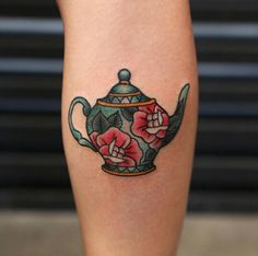 a tattoo on the leg of a woman with a teapot and flowers in it