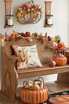 a wooden bench with fall decorations on it