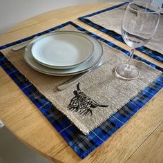 the placemats on the table are decorated with black and blue plaid