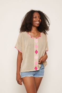 This is it. The perfect post-yoga-gotta-run-to-a-Zoom-meeting top. The hand-embroidered design and colorful details on the neckline and sleeves offer a simple boldness that radiates joy and confidence. Inspired by traditional Habesha Kemis design, this top is a casual staple in any boho chic closet. About the Maker: Menby DesignFounded by Menbere Alemayehu, a native of Ethiopia committed to preserving traditional Ethiopian hand-weaving and hand-embroidery by introducing the techniques into piece Relaxed Fit Multicolor Embroidered Tops, Bohemian Crew Neck Top With Geometric Embroidery, Bohemian Tops With Geometric Embroidery And Crew Neck, Bohemian Pink Crew Neck Top, Pink Bohemian Tops With Crew Neck, Pink Bohemian Crew Neck Top, Casual Geometric Embroidered Tops For Vacation, Casual Geometric Embroidery Tops For Vacation, Short Sleeve Tops With Geometric Embroidery For Vacation