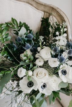 a bouquet of white flowers sitting on top of a chair