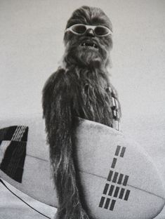 a black and white photo of a chew - man holding a surfboard with the words happy friday written on it