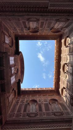 looking up at the sky through an ornate window