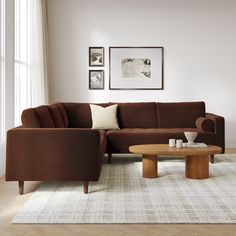 a living room with a sectional couch and coffee table