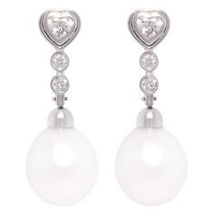 The drop earrings feature a heart shape diamond design with diamonds suspending two South Sea pearls of 15.5 x 14mm. The untreated South Sea pearls originate from the waters of Northwestern Australia. They display a beautiful nacre and their natural color and high luster have not been enhanced in any way. The two heart shape diamonds weigh a total of 0.70 carats. The round diamonds weight a total of 0.40 carats. All diamonds are of top quality (F/G-VVS, color, clarity and cut). The earrings are Gold For Sale, Earrings Design, Heart Shaped Diamond, Diamond Drop Earrings, South Seas, South Sea Pearls, Sea Pearls, Two Hearts, Diamond Design