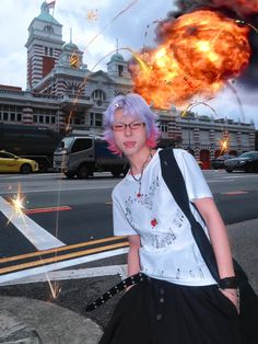 a woman with pink hair and glasses standing in front of a firework display on the street