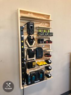 a wooden shelf with many different types of cameras and equipment on it's sides