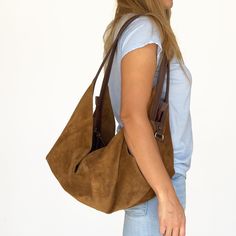 DeLuna is a large hobo bag designed for women who love to carry slouchy handbags. Featured in this listing in camel tone suede leather it has plenty of room for all your essentials which makes it the perfect carryall bag.  The contrast of the two-tone colors on the straps and on the main body is what makes the design unique and stand out. The straps sit comfortably on your shoulder and the bag is secured with a top zipper closure.  Inside the bag, there is one main compartment with a large zippe Slouchy Handbags, Suede Hobo Bag, Slouch Bag, Large Hobo Bag, Slouch Bags, Suede Handbags, Shoulder Bag Brown, Hobo Bags, Large Shoulder Bags